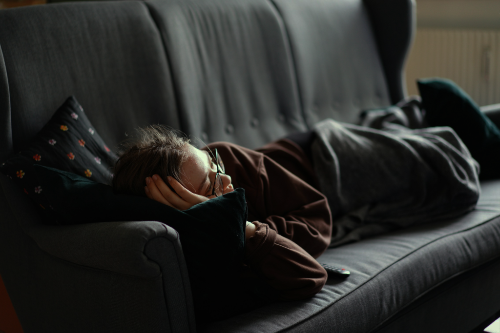 Woman being lazy lying on sofa